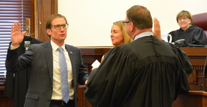photo of Judge Brent Powell taking oath of office from Chief Justice Zel Fischer