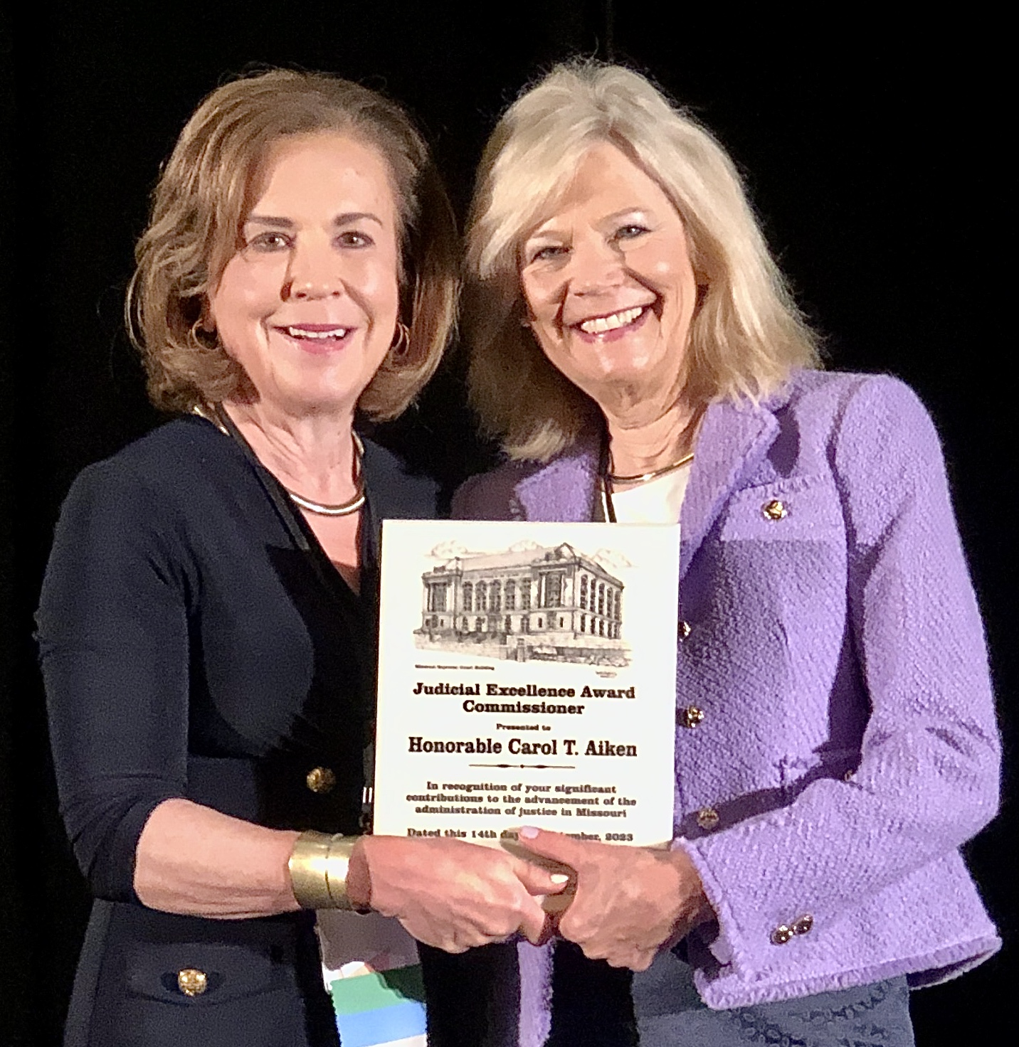 Chief Justice Mary Russell presents award to Commissioner Carol Aiken