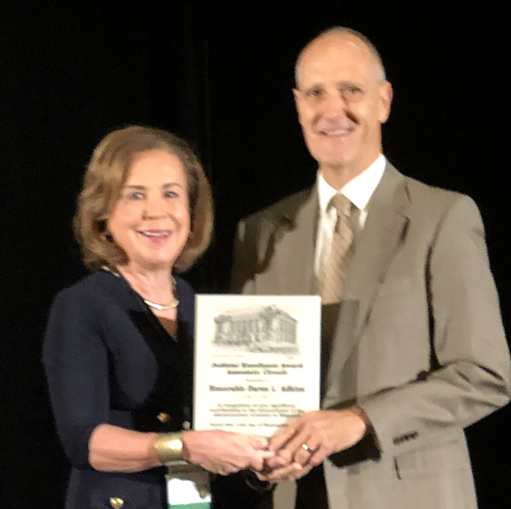 Chief Justice Mary Russell presents award to Judge Daren Adkins
